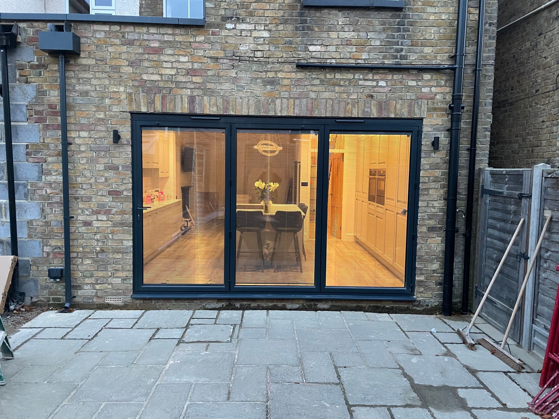 Rear single-storey extension creating an open-plan kitchen-diner with French doors and a new patio.
