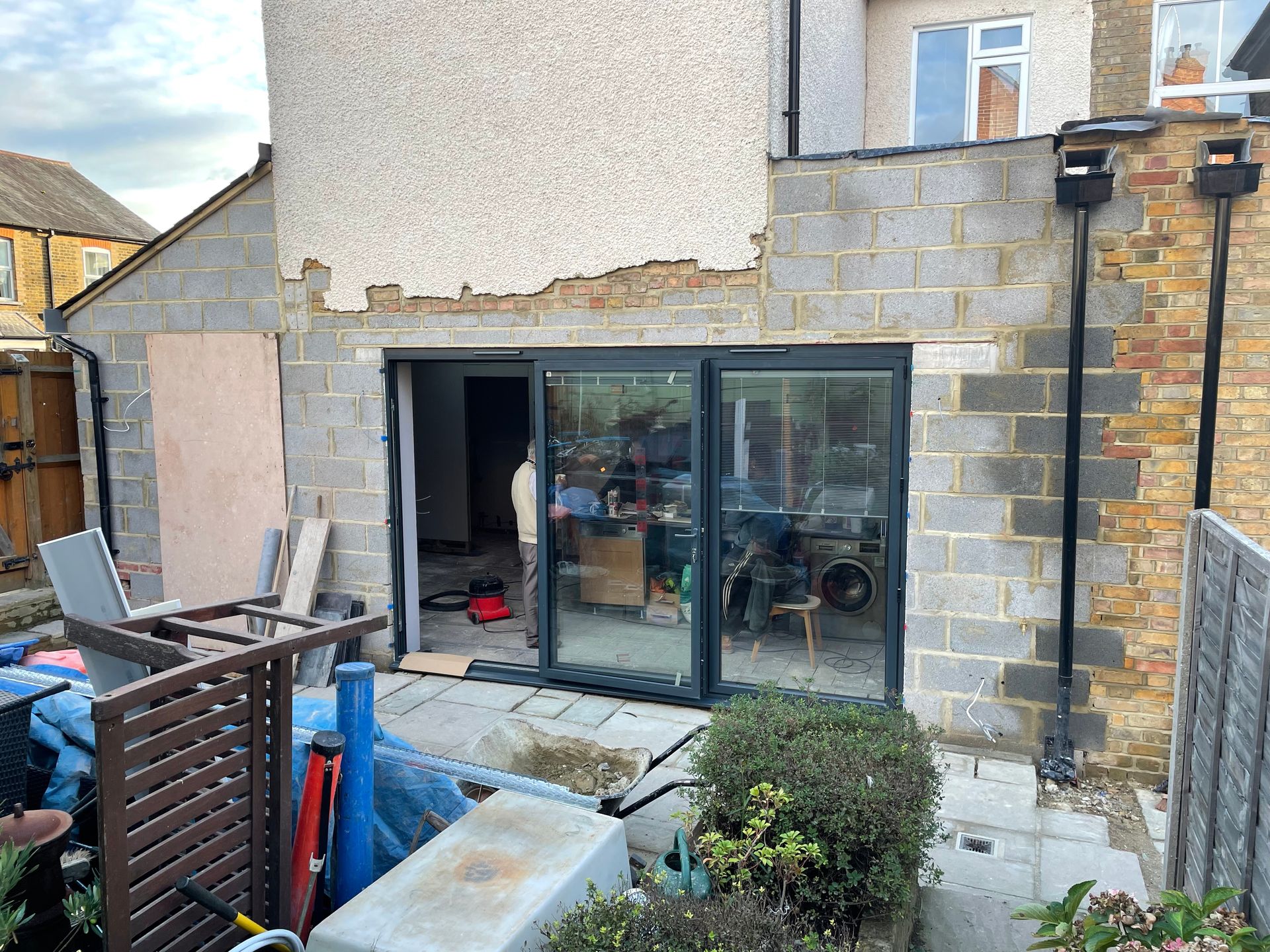 Rear extension with structural steel beam, vaulted ceiling with Velux lights, and French doors to garden.
