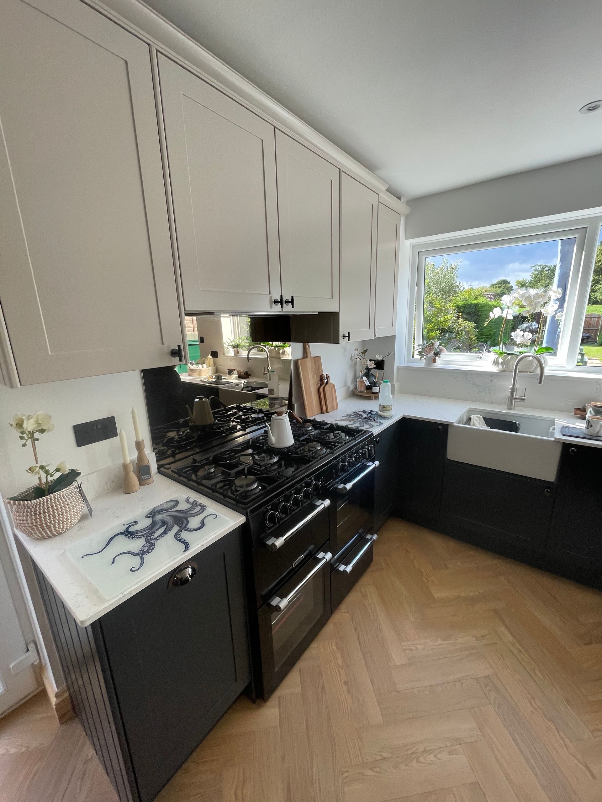 Kitchen after renovation by MJD — bespoke cabinetry and herringbone floor