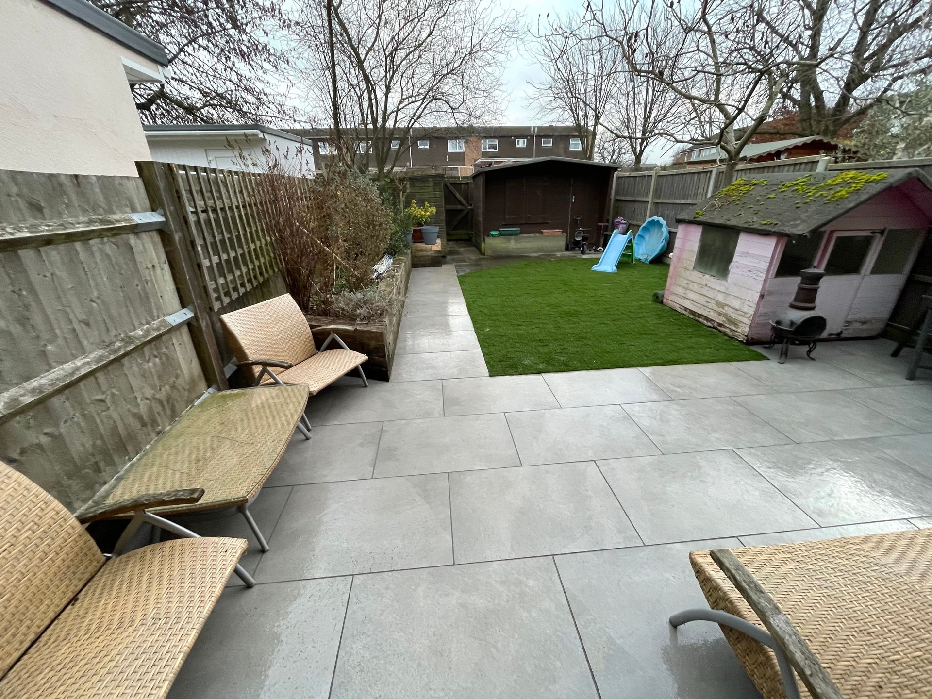Garden makeover with new porcelain paving, turfed lawn, and planted borders.