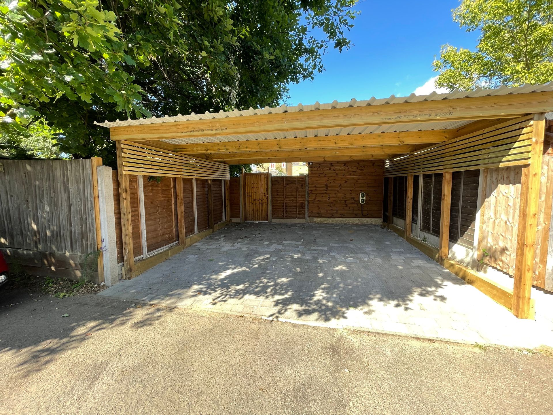 New block paved driveway with drainage channel, soldier course border, and a dropped kerb.