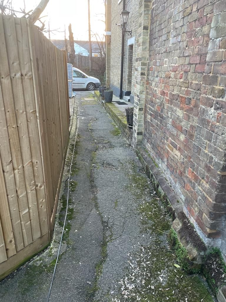 Porcelain paving installation creating defined outdoor dining and seating zones with clean lines throughout.